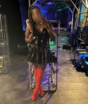 Kinky British black girl in black PVC and knee high red boots