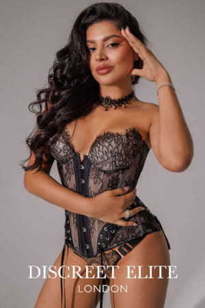 Exotic looking girl with big brown eyes wearing a sexy lace basque