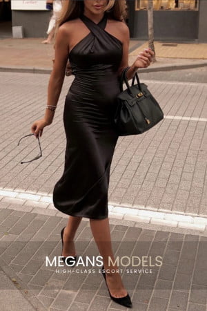 Genuine fashion model in striking black dress and heels
