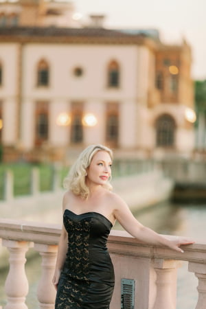 Beautiful mature blonde woman standing in front of an impressive building
