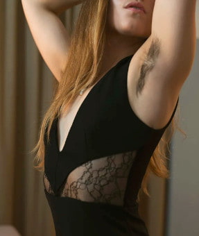 Body shot of a petite dark haired French girl with naturally hairy armpits