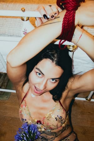 Blue-eyed brunette girl with her hands tied up